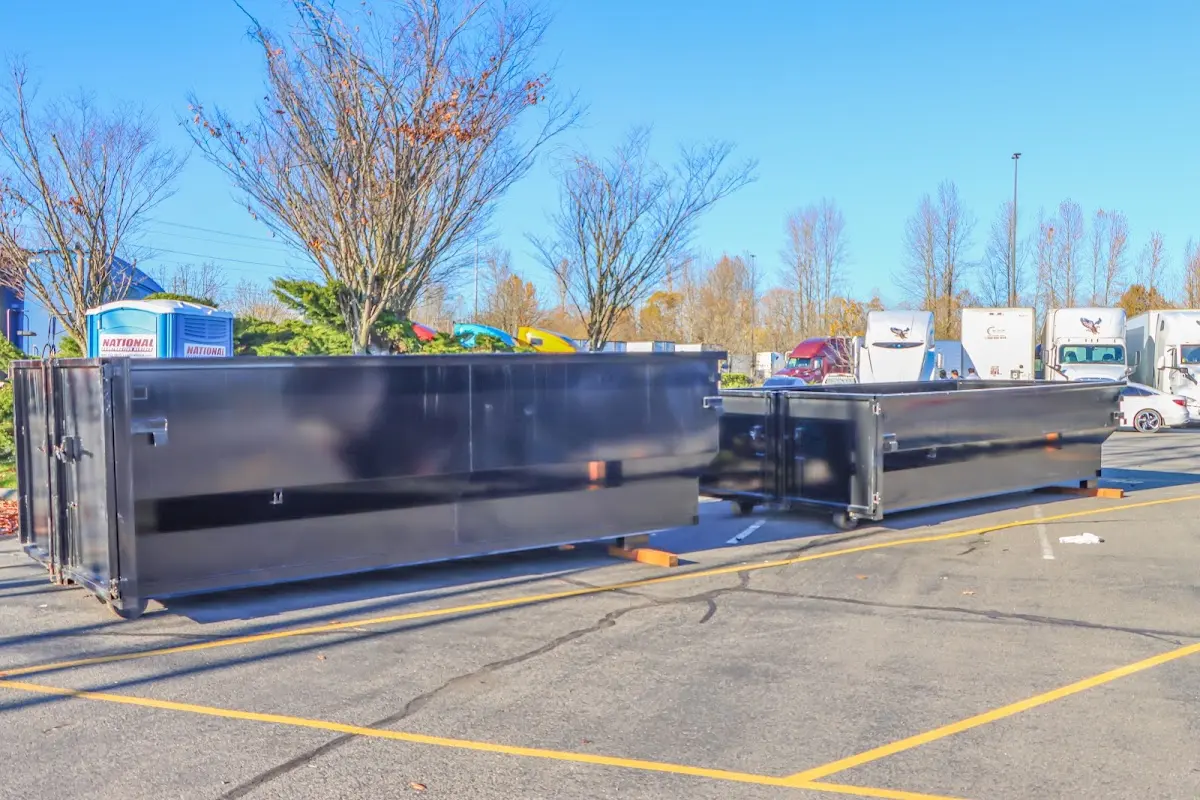 Professional dumpster rental service with roll-off container on residential driveway in Greer